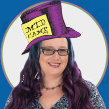 A smiling woman wearing the MidCamp Hatter Hat